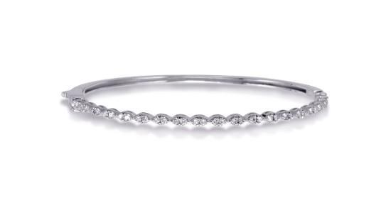 A delicate, silver bangle bracelet with round cut diamonds