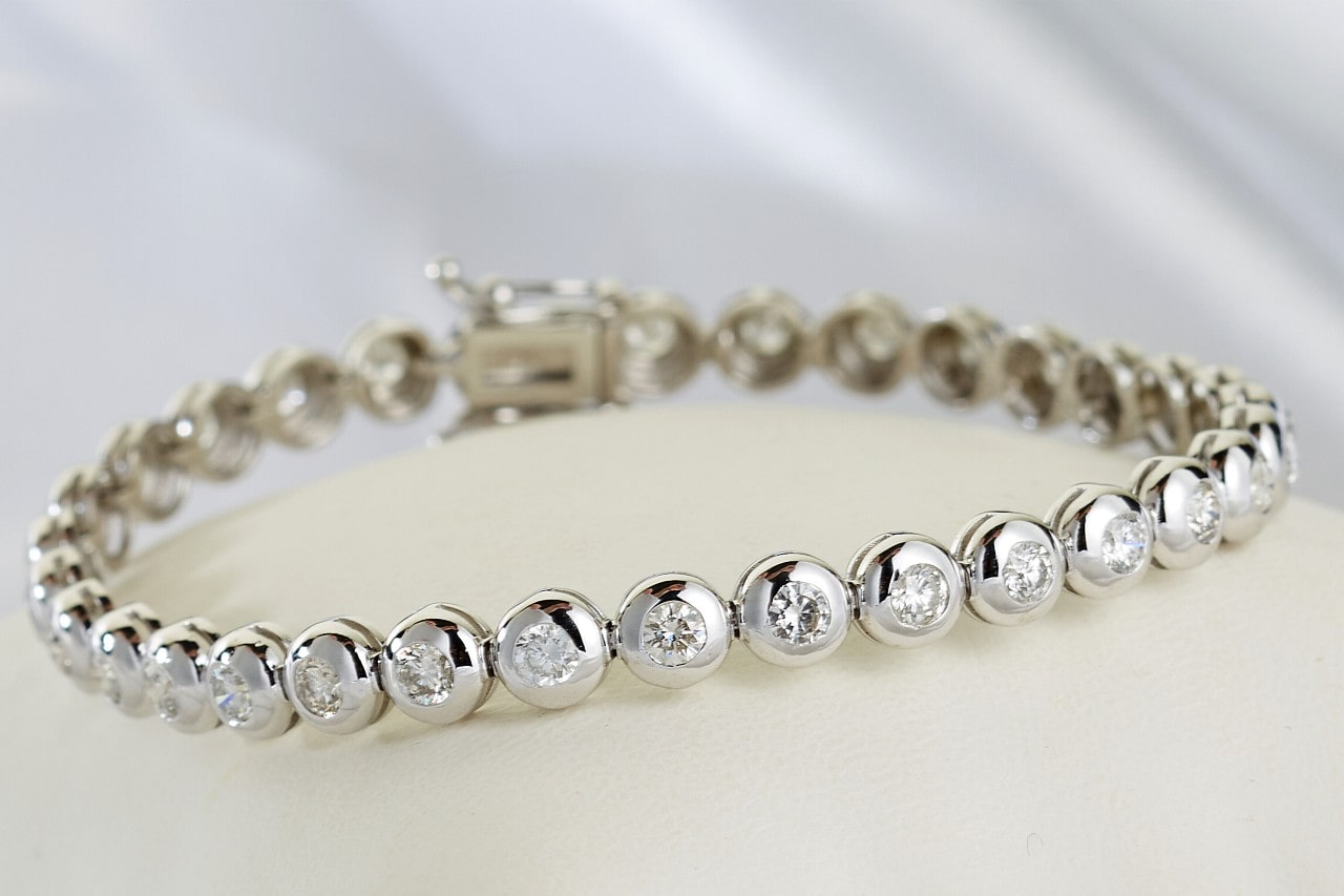 Silver line bracelet with round cut diamonds on a white surface
