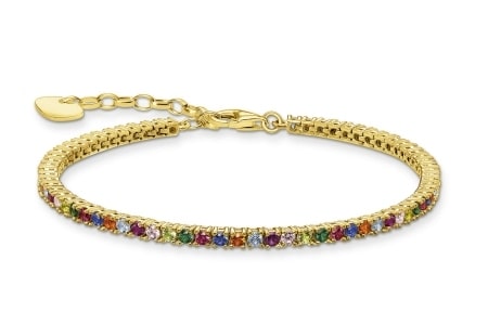 A gold tennis bracelet features colourful glass-ceramic stones