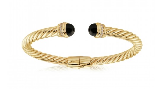 A yellow gold cuff bracelet by Miss Mimi with black domed details