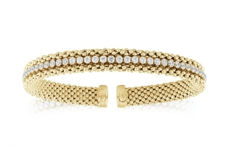 a gold bangle bracelet with cubic zirconia accents from Miss Mimi.