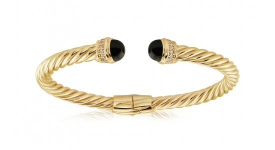 a yellow gold cuff bracelet dotted with two black onyx details