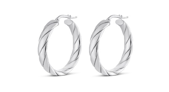 a pair of sculptural silver huggie earrings by Miss Mimi