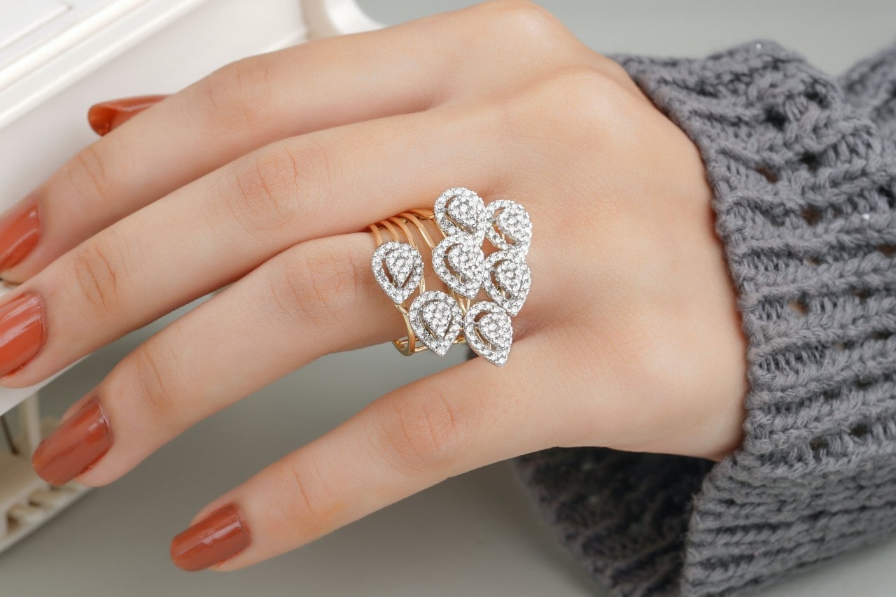 A close-up of a woman’s hand wearing a distinctive and opulent fashion ring.