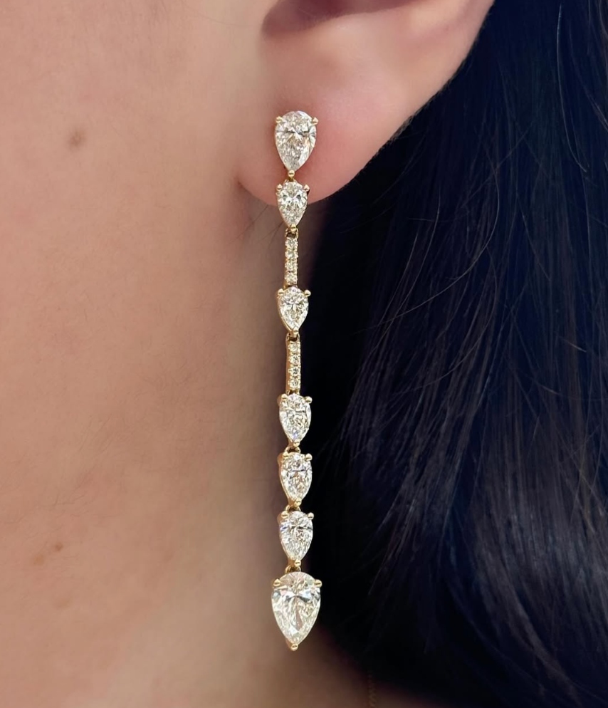 Fancy shape diamonds set in yellow gold for an exquisite set of drop earrings