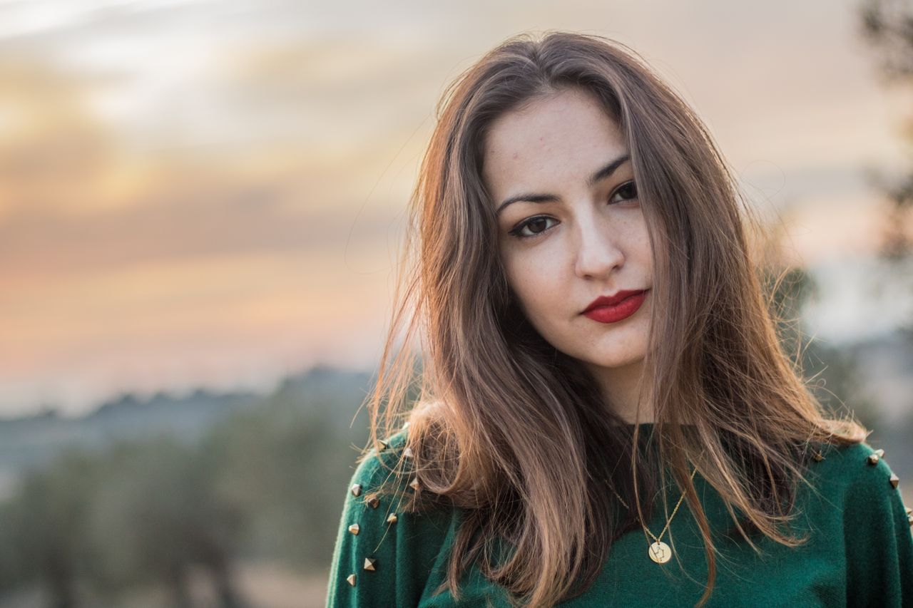 beautiful gold necklace on woman in green sweater